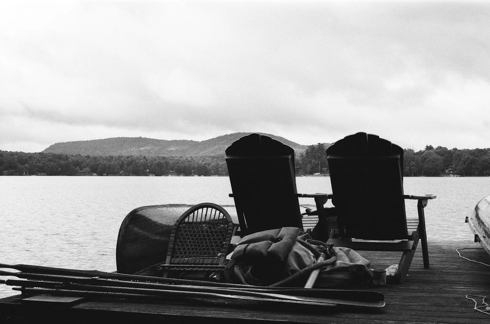 Adirondack chairs and a canoe on a private dock