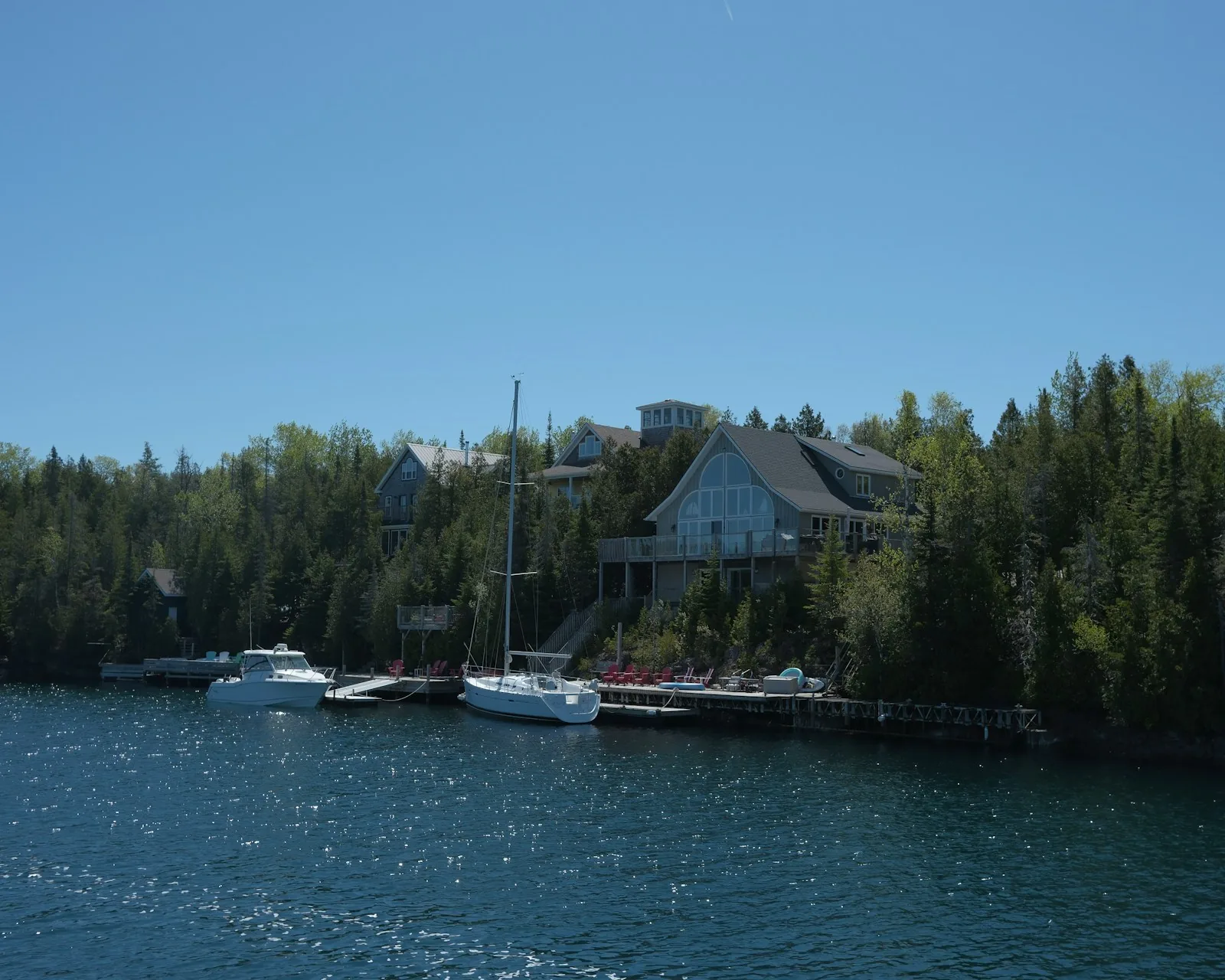 Homes and private docks along a wooded lake shoreline