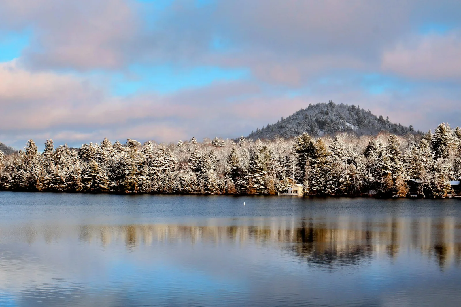 A snow-covered Adirondack lakeshore in winter